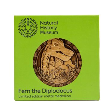 The limited-edition Fern the Diplodocus Metal Medallion in its lime-green packaging.
