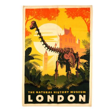 The cream Museum Gardens Tea Towel with a large, yellow/orange print of Fern the Diplodocus surrounded by green foliage and a large sun.